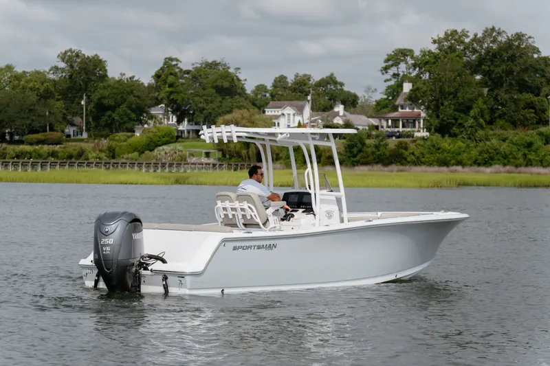 Slide: The Image of 2023 Sportsman Heritage 231 Center Console boat cruising on a calm river. - 16