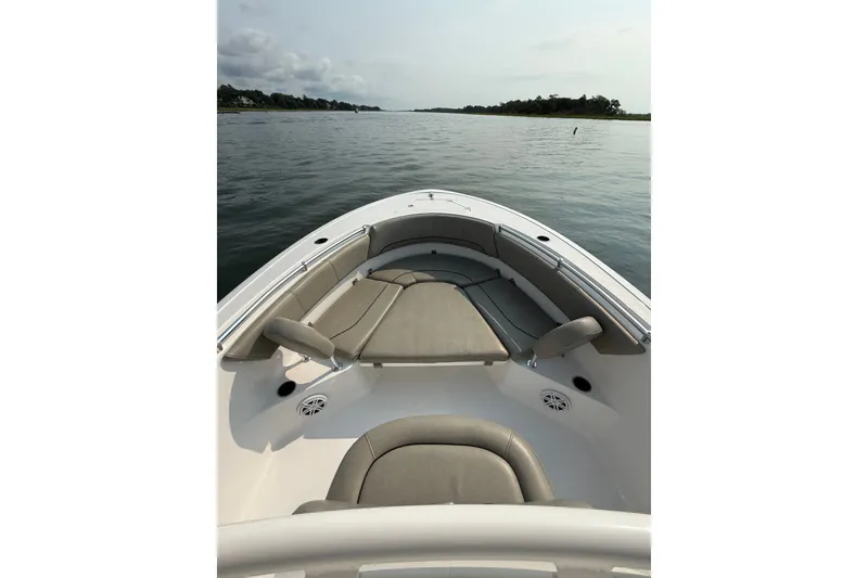Slide: The Image of 2023 Sportsman Heritage 231 Center Console boat on calm water, featuring spacious seating. - 7