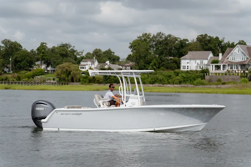 Slide: The Image of 2023 Sportsman Heritage 231 Center Console boat cruising on a serene lake. - 3