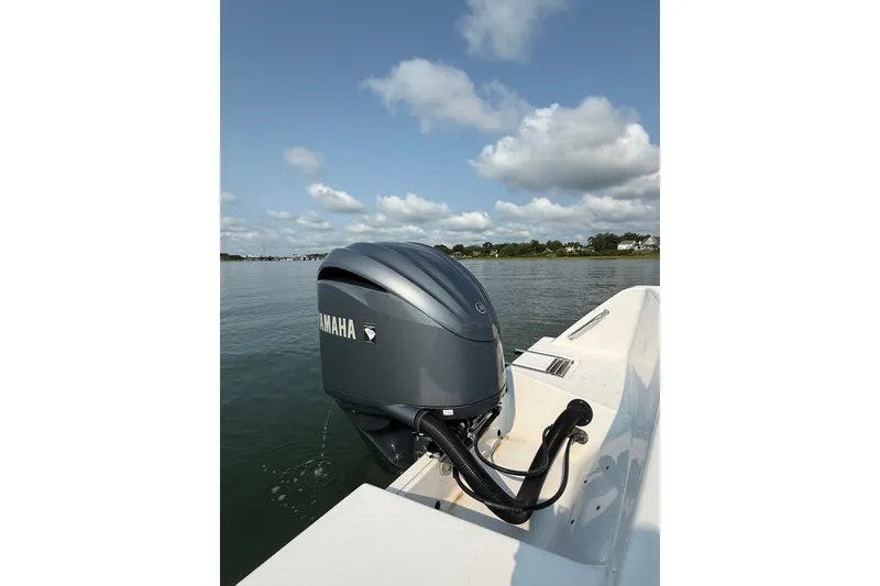 Slide: The Image of 2023 Sportsman Heritage 231 Center Console boat with Yamaha outboard motor on calm water. - 23