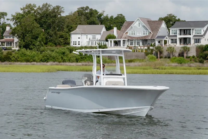 Slide: The Image of 2023 Sportsman Heritage 231 Center Console boat cruising near waterfront homes. - 21