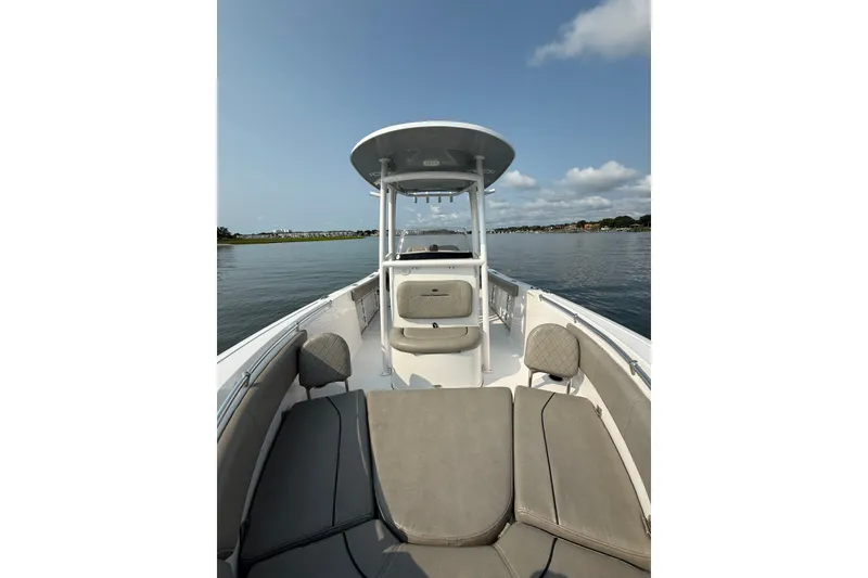 Slide: The Image of 2023 Sportsman Heritage 231 Center Console boat on calm water, featuring spacious seating. - 6