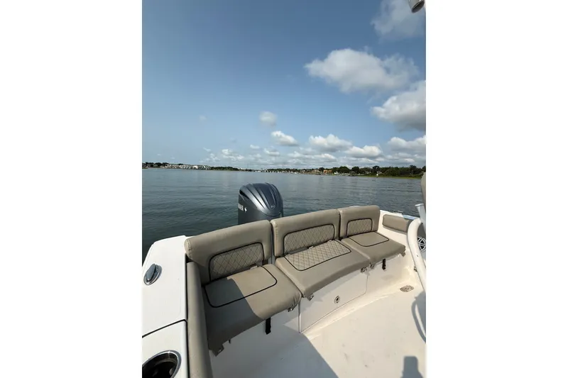 Slide: The Image of 2023 Sportsman Heritage 231 Center Console boat on calm water, featuring comfortable seating. - 14