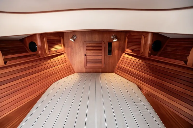 Slide: The Image of Interior of 2012 Hinckley Picnic Boat MKIII with wooden paneling and cozy cabin space. - 3
