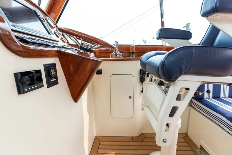 Slide: The Image of Interior of 2012 Hinckley Picnic Boat MKIII with wooden dashboard and blue seating. - 13