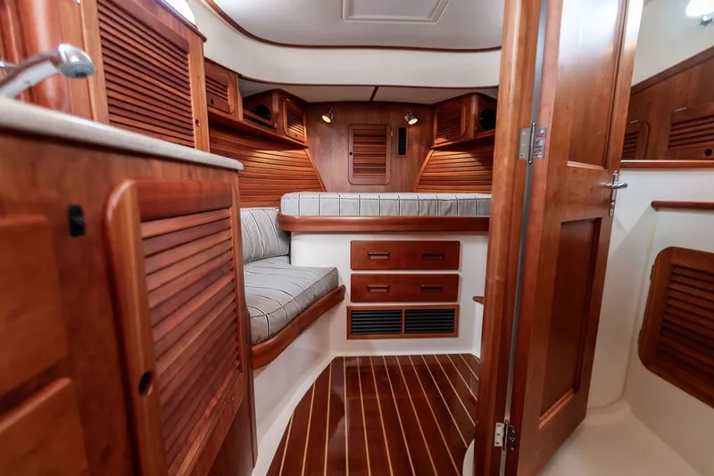Slide: The Image of Luxurious 2012 Hinckley Picnic Boat MKIII interior with elegant wood finish and cozy seating. - 14