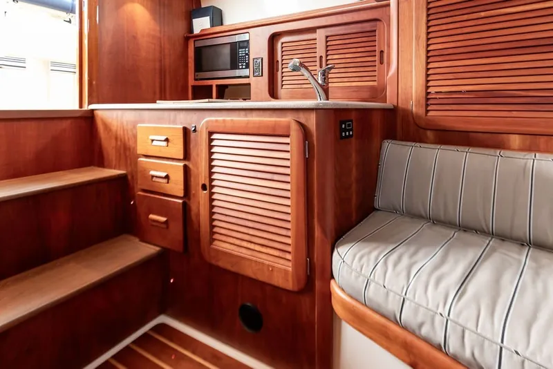 Slide: The Image of Interior of 2012 Hinckley Picnic Boat MKIII with wood cabinetry and seating. - 17