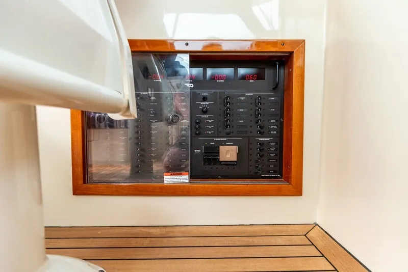Slide: The Image of Hinckley Picnic Boat MKIII 2012 electrical panel with wooden frame and digital displays. - 24