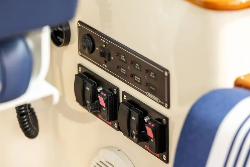 Slide: The Image of Control panel of a 2012 Hinckley Picnic Boat MKIII with switches and indicators. - 12