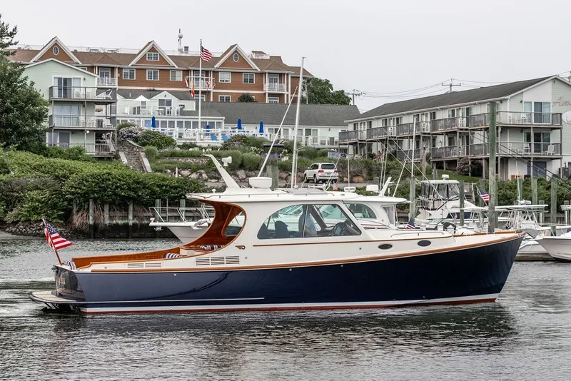 Slide: The Image of Hinckley Picnic Boat MKIII 2012 cruising in a marina with waterfront buildings in the background. - 6
