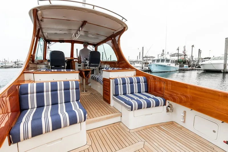 Slide: The Image of Hinckley Picnic Boat MKIII 2012 with striped seating, docked at a marina. - 29