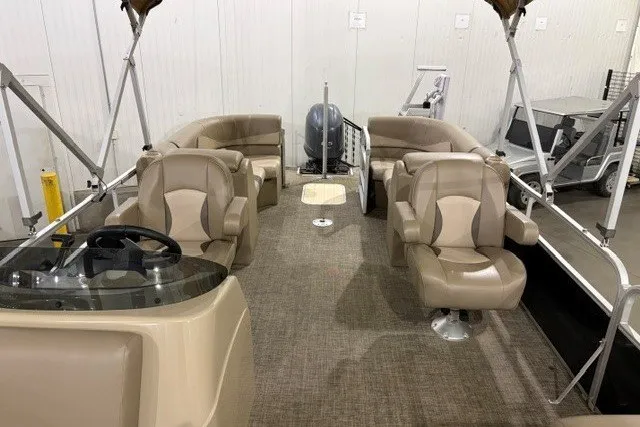 Slide: The Image of 2015 SunCatcher V22 RC pontoon boat interior with beige seating and steering console. - 8