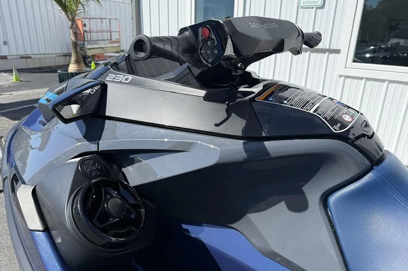 Slide: The Image of 2024 Sea-Doo GTX 230 jet ski, close-up of handlebars and controls, outdoors. - 6