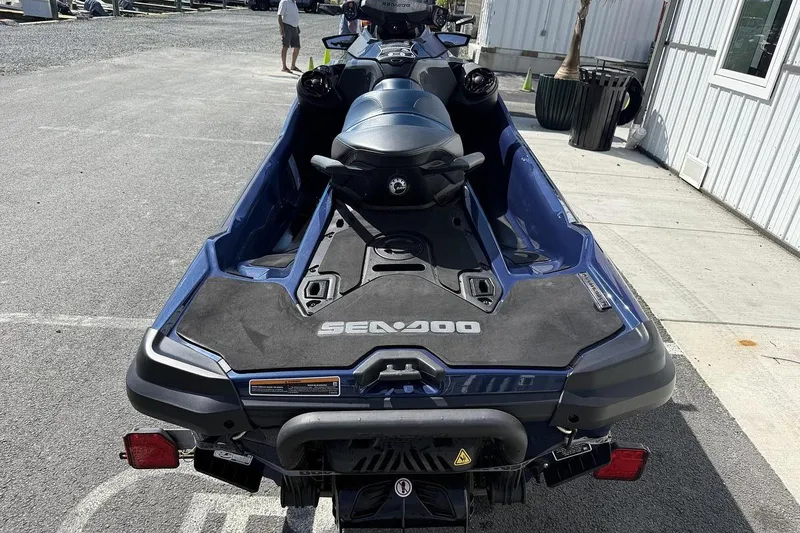 Slide: The Image of 2024 Sea-Doo GTX 230 jet ski, blue, parked outdoors on pavement. - 7