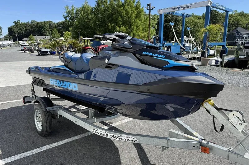 Slide: The Image of 2024 Sea-Doo GTX 230 jet ski on trailer at marina, ready for adventure. - 3