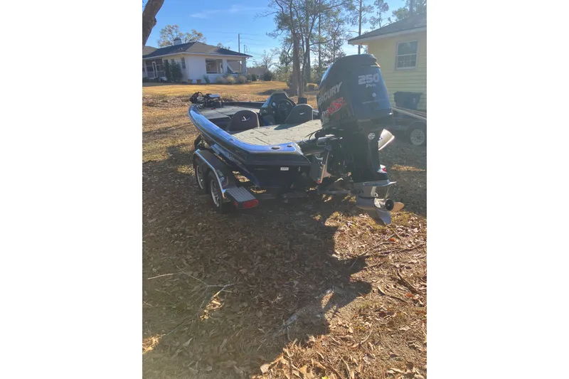 Slide: The Image of 2016 Blazer 202 Pro-V boat with Mercury 250 Pro XS engine in a yard setting. - 4