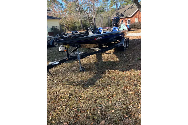 Slide: The Image of 2016 Blazer 202 Pro-V boat on trailer in residential yard. - 2