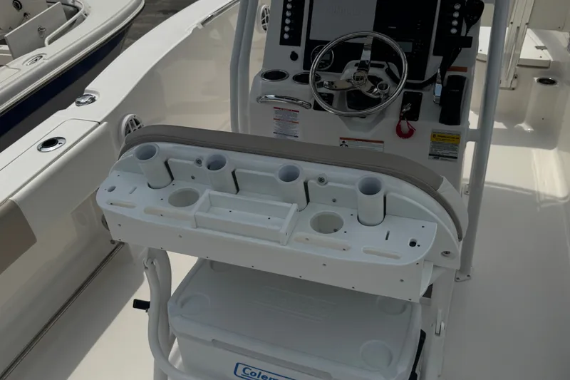Slide: The Image of 2023 Robalo R200 Center Console boat helm with steering wheel and rod holders. - 13