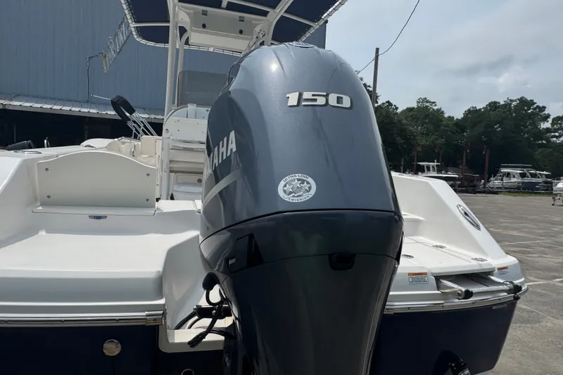 Slide: The Image of 2023 Robalo R200 Center Console with Yamaha 150 engine, docked outdoors. - 10