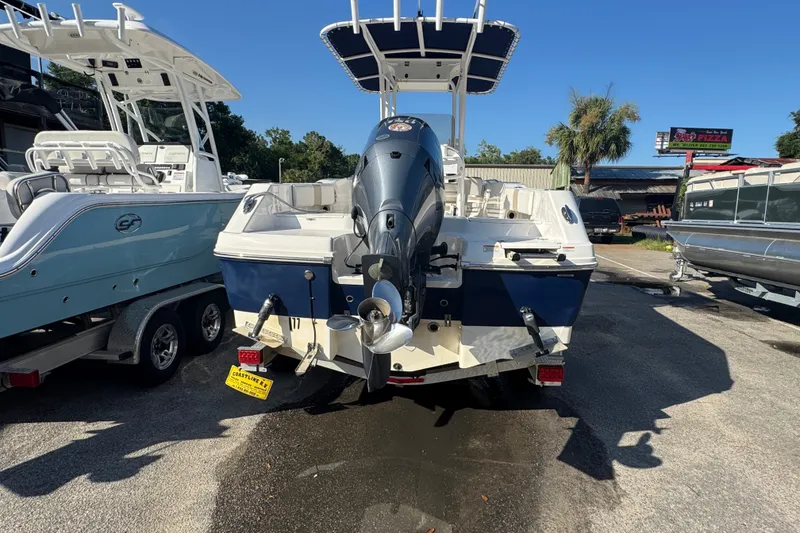 Slide: The Image of 2023 Robalo R200 Center Console boat with outboard motor, parked outdoors. - 5