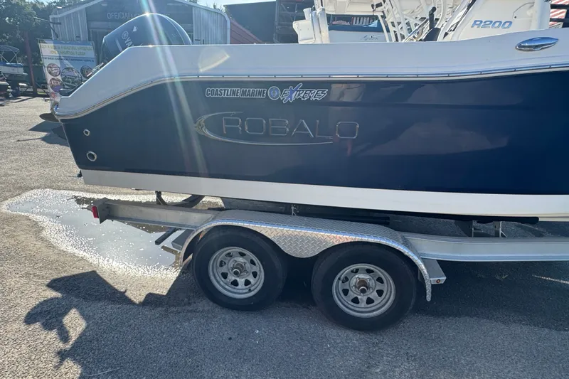 Slide: The Image of 2023 Robalo R200 Center Console boat on trailer, side view in sunlight. - 6