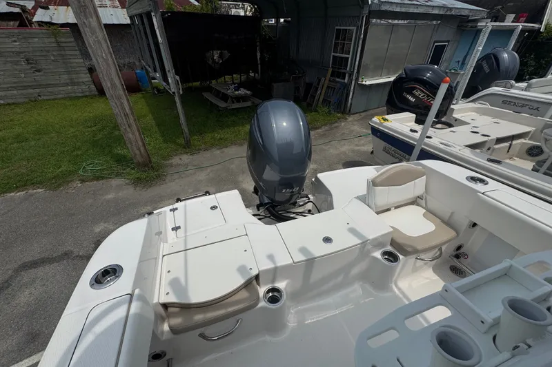 Slide: The Image of 2023 Robalo R200 Center Console boat with Yamaha outboard engine in a yard. - 15