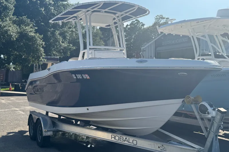 The Image of 2023 Robalo R200 Center Console boat on trailer, parked outdoors. - 1