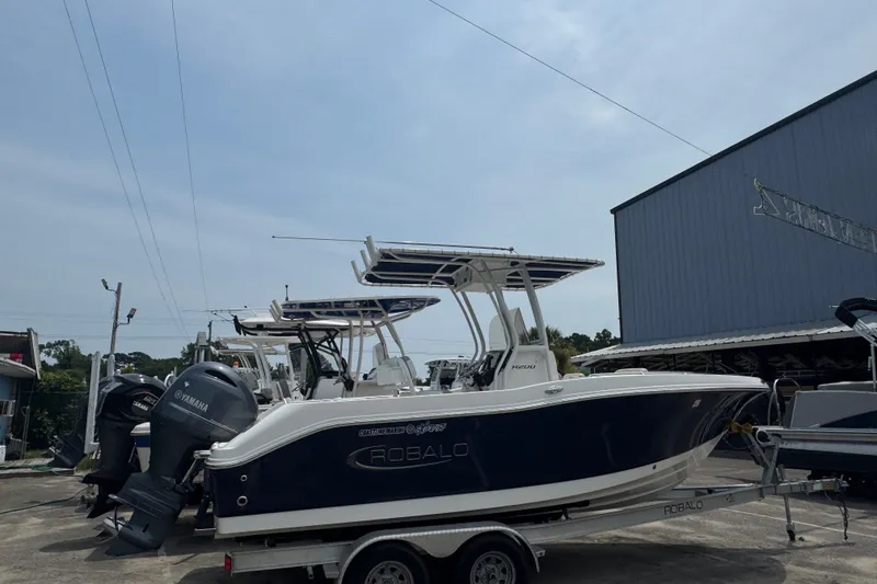 Slide: The Image of 2023 Robalo R200 Center Console boat on trailer, parked outdoors. - 9