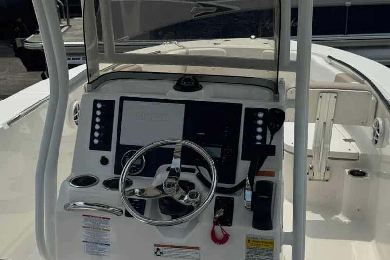 Slide: The Image of 2023 Robalo R200 Center Console boat dashboard with steering wheel and navigation controls. - 14