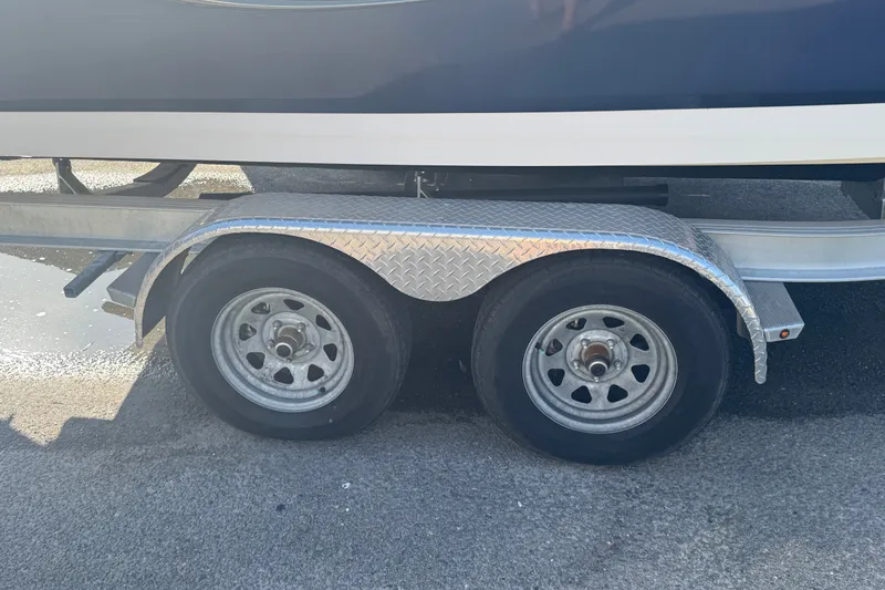 Slide: The Image of Trailer wheels of 2023 Robalo R200 Center Console boat on pavement. - 3