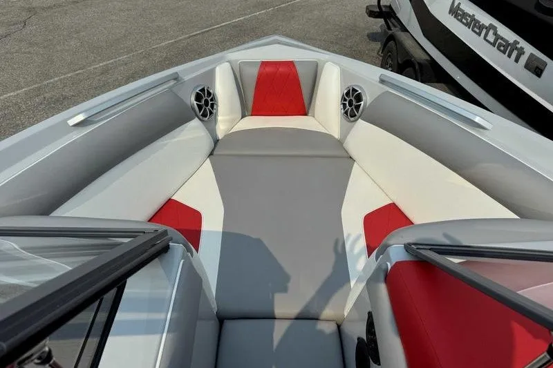 Slide: The Image of 2018 Tigé R21 boat interior with red and gray seating, featuring speakers. - 6