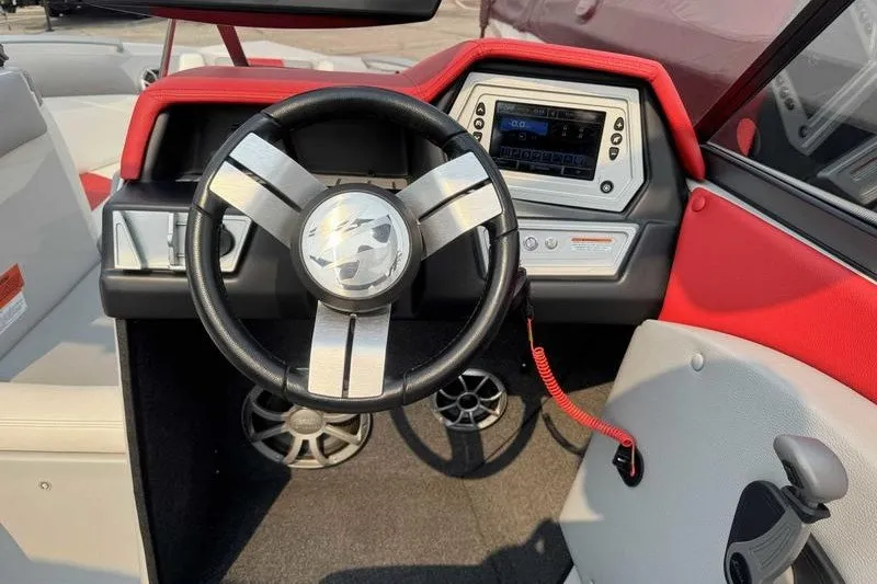 Slide: The Image of 2018 Tigé R21 boat dashboard with steering wheel and control panel. - 9