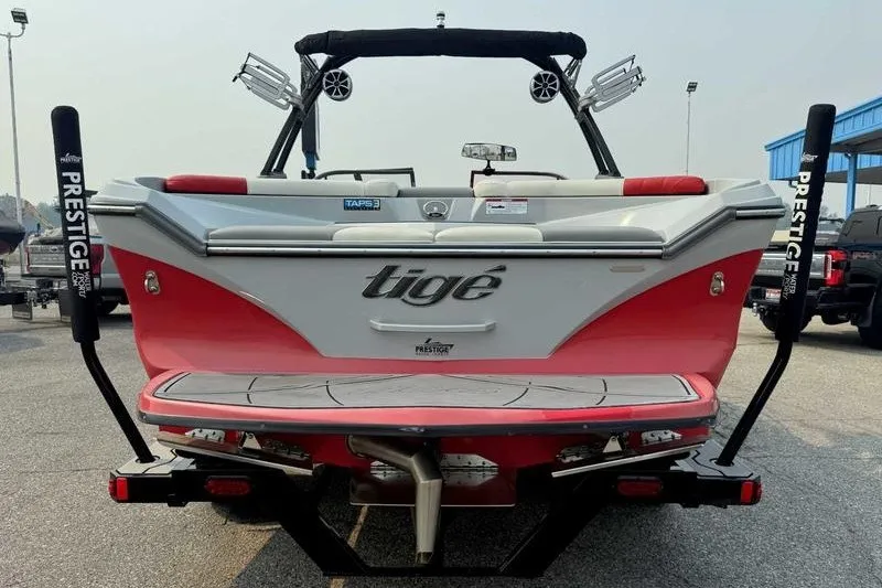 Slide: The Image of 2018 Tigé R21 boat, red and white, on trailer at marina. - 14