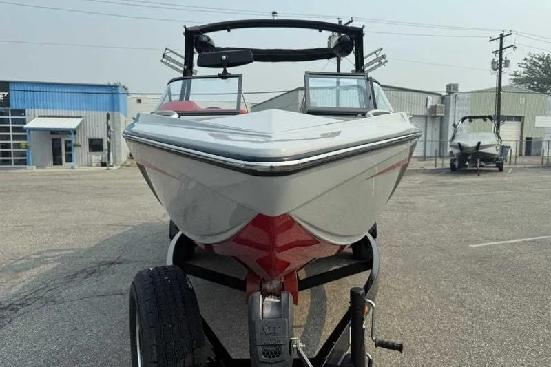 Slide: The Image of 2018 Tigé R21 boat on trailer in industrial parking lot. - 15