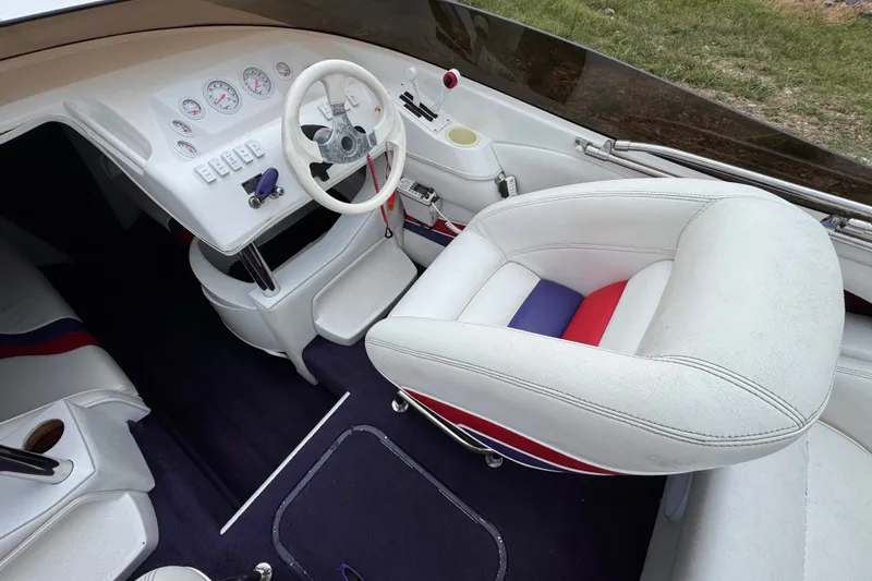 Slide: The Image of 2006 Nordic Powerboats 25 Rage cockpit with white seating and modern dashboard controls. - 5