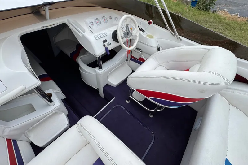 Slide: The Image of 2006 Nordic Powerboats 25 Rage interior with white seating and modern dashboard design. - 7