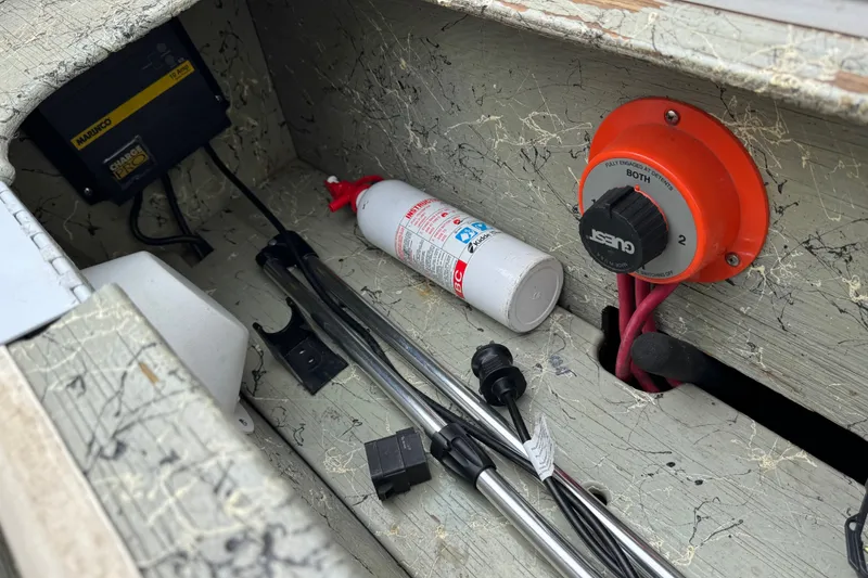 Slide: The Image of Storage compartment of a 2006 Nordic Powerboats 25 Rage with tools and safety equipment. - 15