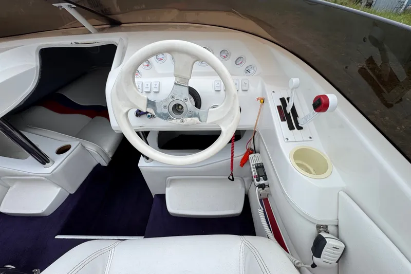 Slide: The Image of Interior of a 2006 Nordic Powerboats 25 Rage, featuring steering wheel and controls. - 6