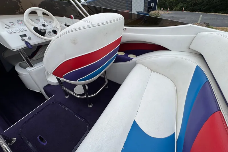 Slide: The Image of Interior of a 2006 Nordic Powerboats 25 Rage with colorful seating and dashboard. - 9