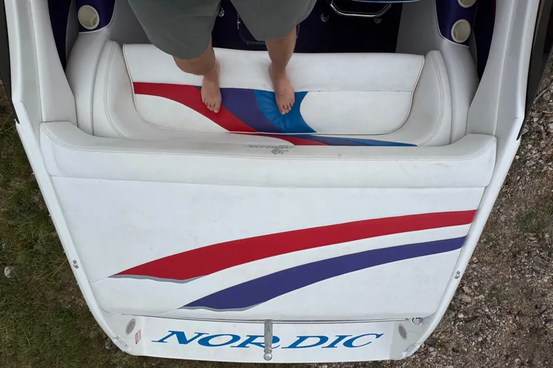 Slide: The Image of Man standing on Nordic Powerboats 25 Rage 2006 boat with colorful seat design. - 17