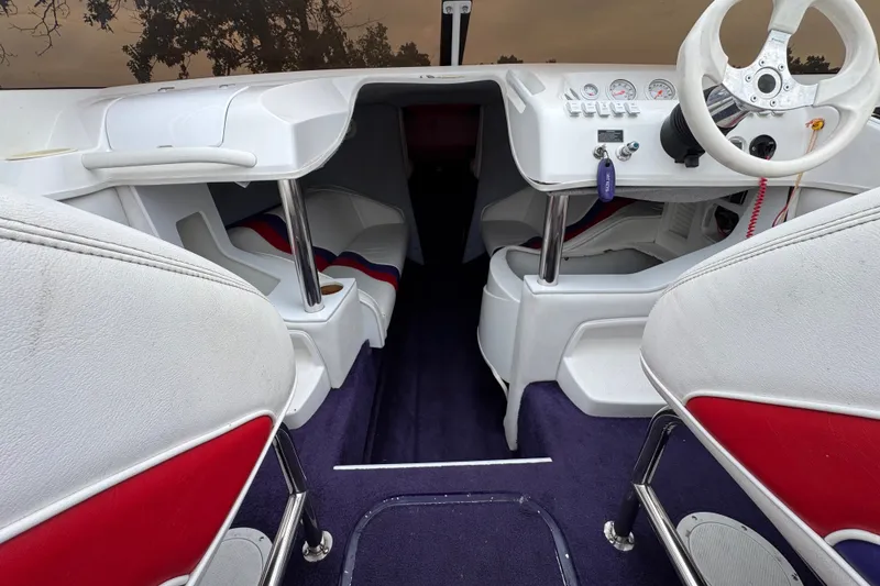 Slide: The Image of Interior of a 2006 Nordic Powerboats 25 Rage, featuring white and red seating. - 8