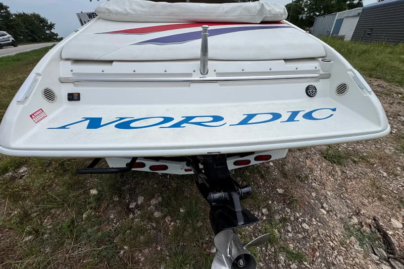 Slide: The Image of Rear view of a 2006 Nordic Powerboats 25 Rage, showcasing the boat's stern and propeller. - 2