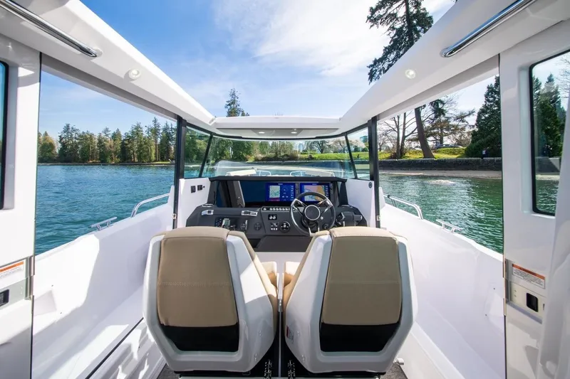 Slide: The Image of Interior view of 2027 Axopar 29 XC Cross Cabin boat on a scenic waterway. - 10
