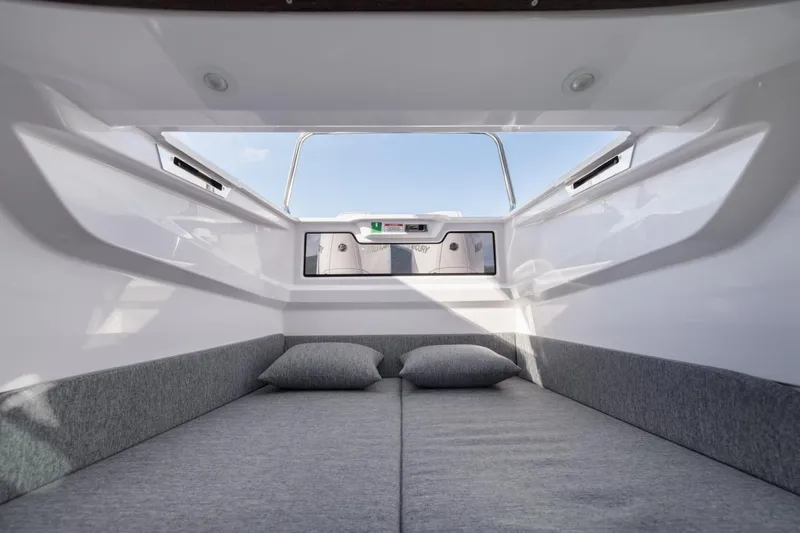 Slide: The Image of Interior cabin view of 2027 Axopar 29 XC Cross Cabin, featuring cozy bedding and modern design. - 9