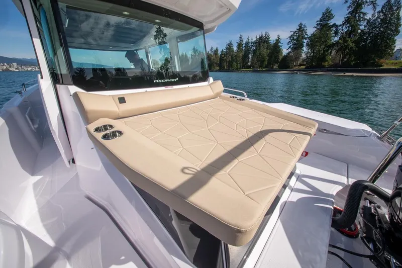 Slide: The Image of 2027 Axopar 29 XC Cross Cabin boat with sunbed, on a scenic lake. - 7