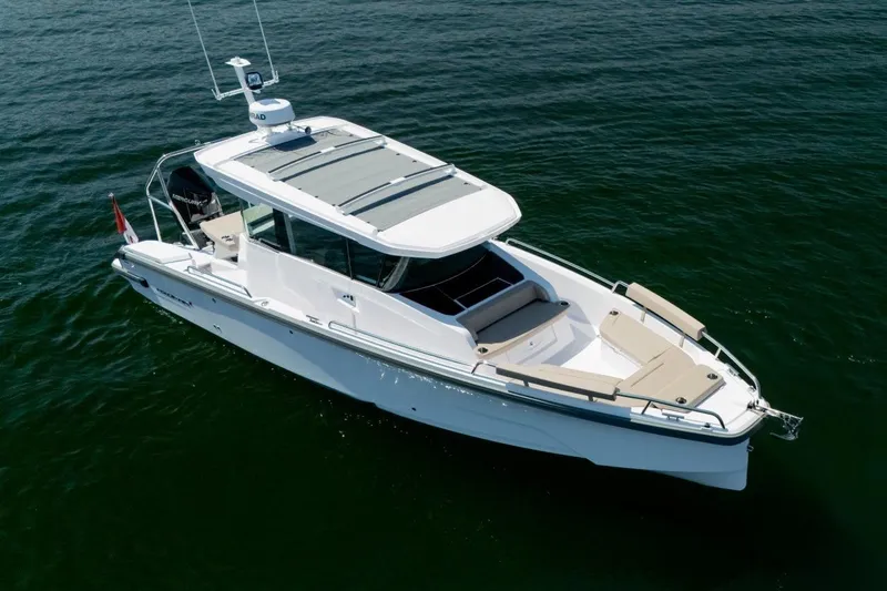 Slide: The Image of 2027 Axopar 29 XC Cross Cabin boat cruising on open water. - 2