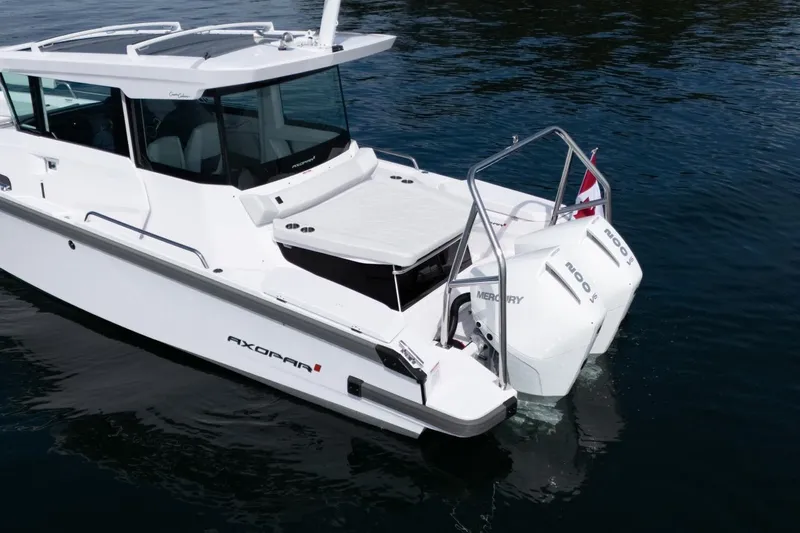 Slide: The Image of 2027 Axopar 29 XC Cross Cabin boat with dual Mercury engines on water. - 3