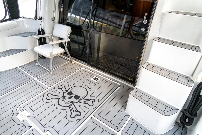 Slide: The Image of Carver 450 Voyager Pilothouse 2000 yacht deck with skull and crossbones design. - 12