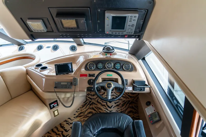 Slide: The Image of Interior of 2000 Carver 450 Voyager Pilothouse with steering wheel and navigation equipment. - 37