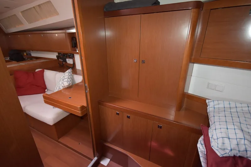 Slide: The Image of Interior of 2012 Beneteau Oceanis 41.1 yacht with wooden cabinetry and cozy seating area. - 54